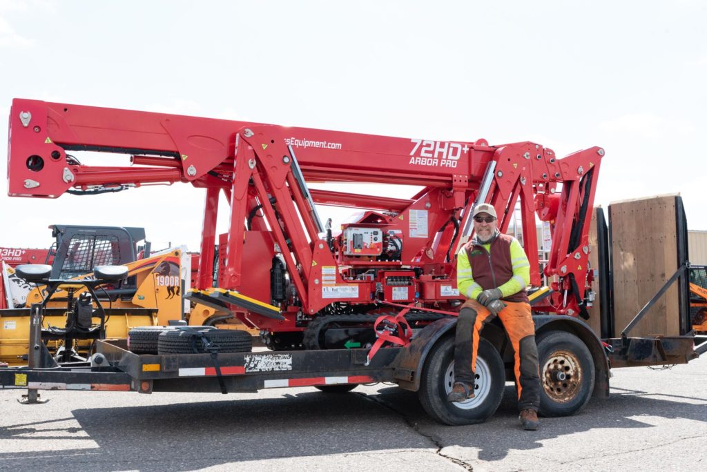 George sits on a trailer towing our shiny new red Arbor Pro 72 HD+ lift